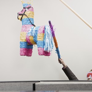 Office workers playing with a pinata