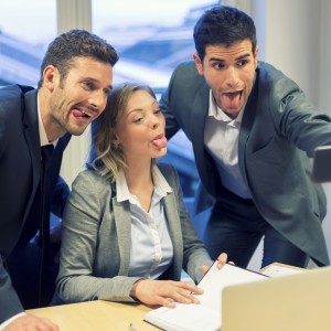 Selfie business team taking pictures in the office. Their tongue